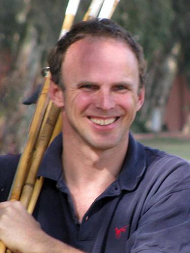 Dan Keating Holding Polo Mallets on His Shoulder